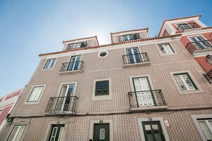 Un edificio de varios pisos con fachada decorada, balcones y ventanas.