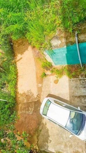 An aerial view of a pathway leading to a pool surrounded by greenery. - Silver Dome (Ella)