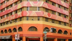 A multi-story building with a distinctive geometric facade and balconies. - San Hua Hotel (Kaohsiung)