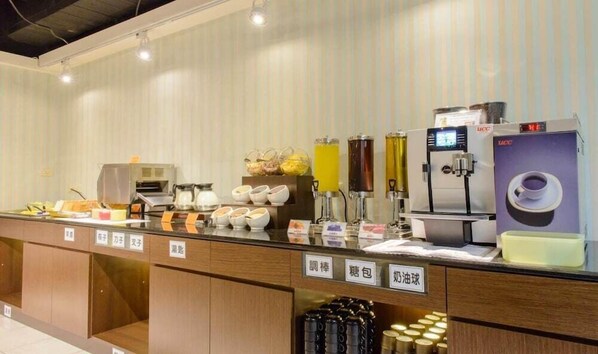 A self-service beverage station with various drink dispensers, a coffee machine, and a tea dispenser. - San Hua Hotel (Kaohsiung)