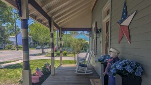 A porch with a rocking chair, American flags, and a star decoration. - Updated 4BR/2BA Victorian - Linens Included, Beach Box, Walkable, Off-Street Parking (West Cape May)