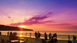 A beach scene with people and tables, likely a public area or restaurant. - The Jimbaran Beach Villa by Ini Vie Hospitality (Jimbaran)