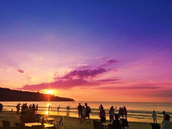 A beach scene with people and tables, likely a public area or restaurant. - The Jimbaran Beach Villa by Ini Vie Hospitality (Jimbaran)