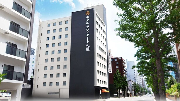 A modern hotel building with a prominent black and white facade, multiple floors, and a visible entrance. - Hotel Raffinato Sapporo (Sapporo)