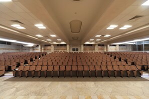 A large, empty auditorium with rows of brown chairs and a high ceiling with recessed lighting. - Mediteran Wellness & Spa, Congress Center (Bečići)