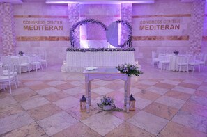 A conference center with a checkered floor, white tables, and chairs arranged for an event. - Mediteran Wellness & Spa, Congress Center (Bečići)
