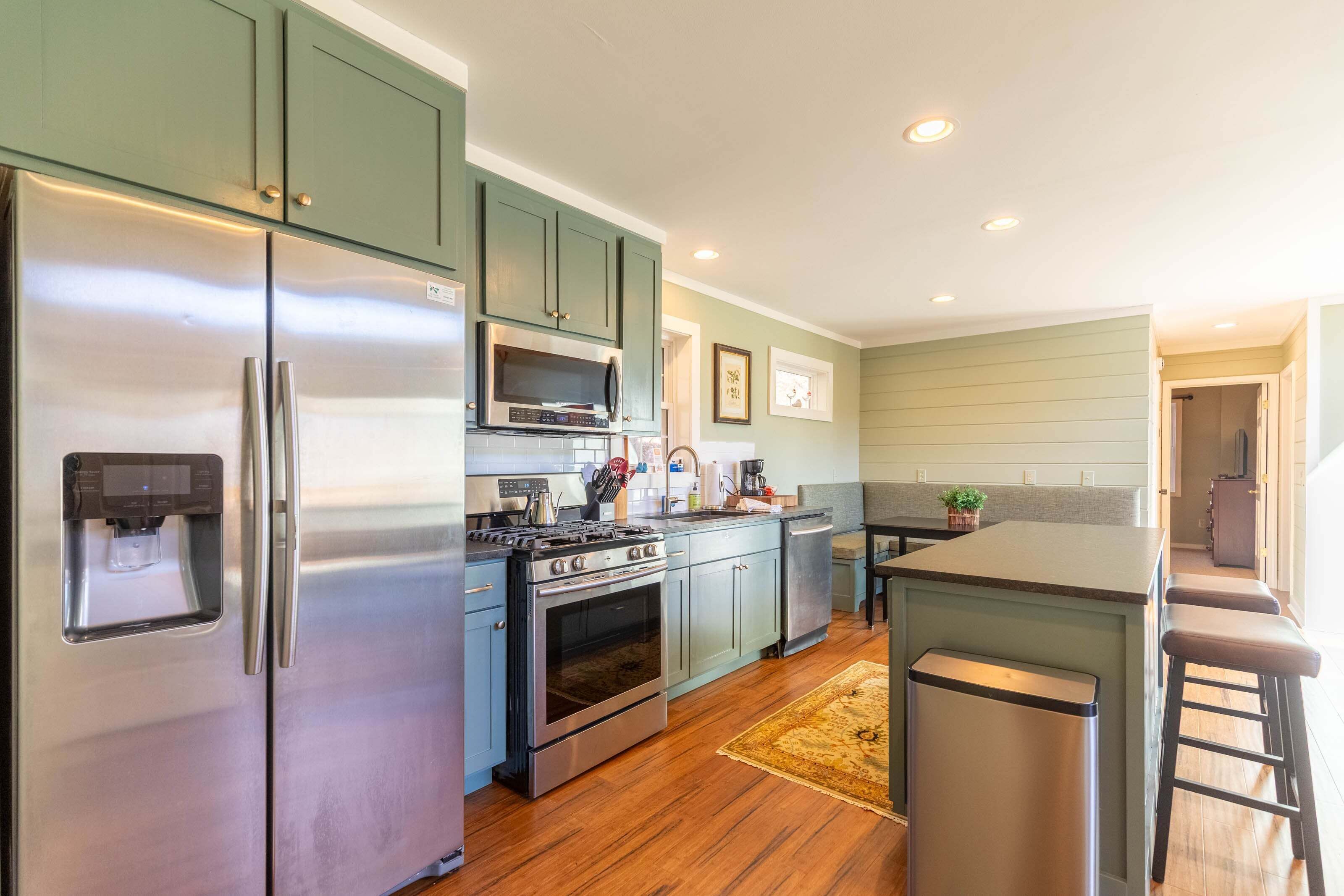 A kitchen with stainless steel appliances, a built-in oven, and a microwave.