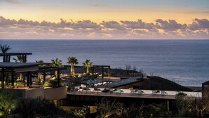 A resort with a pool area, lounge chairs, and a view of the ocean. - Zadun, a Ritz-carlton Reserve (San José del Cabo)