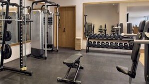 A gym with weightlifting equipment, dumbbells, and a bench. - Zadun, a Ritz-carlton Reserve (San José del Cabo)
