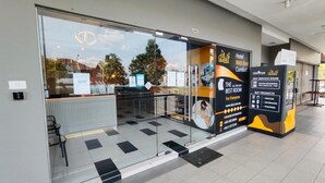 A hotel entrance with a glass door, a self-service kiosk, and a sign advertising 'Hotel with Best Comfort'. - Bangi Business Hotel (Bandar Baru Bangi)