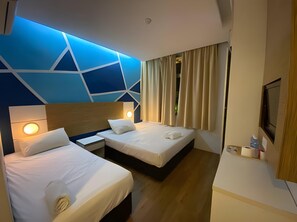 A hotel room with two beds, a TV, and a ceiling light. - Bangi Business Hotel (Bandar Baru Bangi)