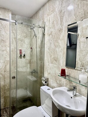 Ein modernes Badezimmer mit einer Duschkabine, einer Toilette und einem Waschbecken.