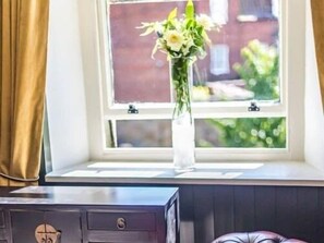 A room with a window, a desk, and a chair. - The Dirty Bottles Inn (Alnwick)