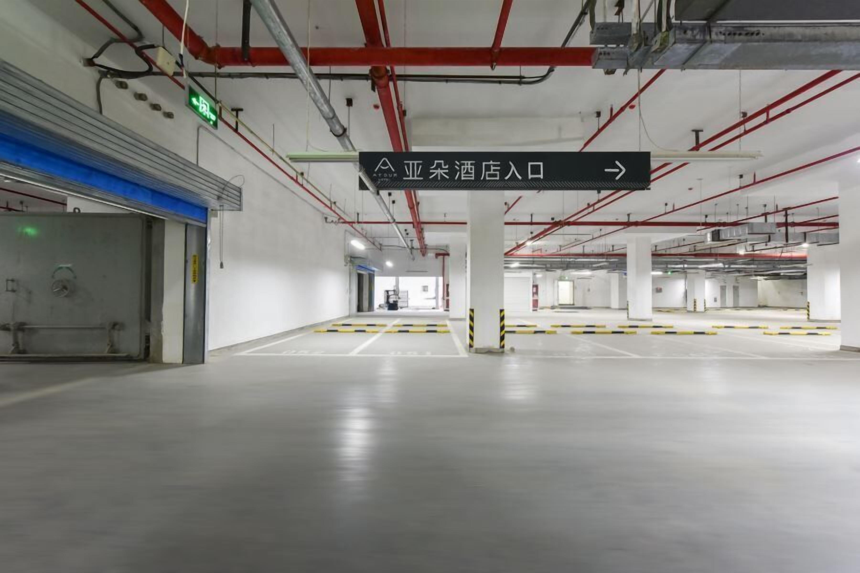 A spacious, well-lit parking garage with clear directional signage and a clean, modern design.