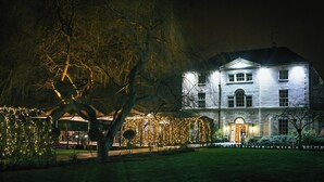 A large, two-story building with a symmetrical facade, a central entrance, and a well-maintained garden. - Hotel Van Dyk (Chesterfield)