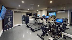 A gym with treadmills, stationary bikes, and a rowing machine. - Hotel Van Dyk (Chesterfield)