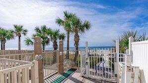 A gated entrance with palm trees and a view of the beach. - Venture Out @ Gulf Highlands Beach Resort Sleeps 6 (Panama City Beach)