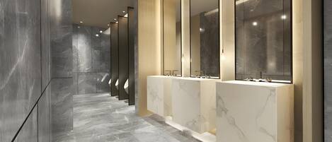 A modern bathroom with marble floors, multiple sinks, and large mirrors.