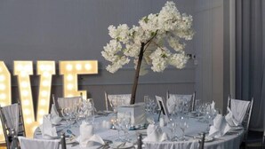 A round table set for a formal event with white tablecloths, silverware, and glassware. - Carrigaline Court Hotel And Leisure Centre (Carrigaline)