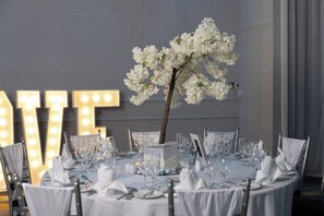 A round table set for a formal event with white tablecloths, silverware, and glassware. - Carrigaline Court Hotel AND Leisure Centre (Carrigaline)