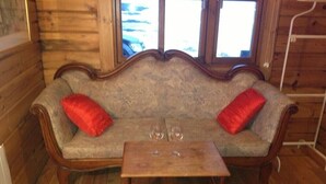 A wooden interior with a sofa and a small table. - North Star Guesthouse (Rangárþing eystra)