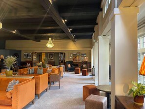 A spacious lobby with seating areas, a chandelier, and artwork on the walls. - Thatchers Bw Signature Collection By Best Western (Leatherhead)