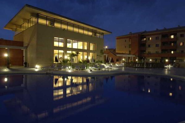A modern hotel with a pool, reflecting the building and surroundings. - Leo Punta Umbria (Punta Umbría)