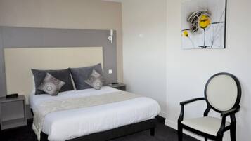 A neatly arranged bedroom with a bed, nightstands, a chair, and a wall-mounted artwork.