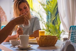 A breakfast setting with a table, a basket, and a cup. - Casa Heredia Boutique By Gb Collection (Cartagena)