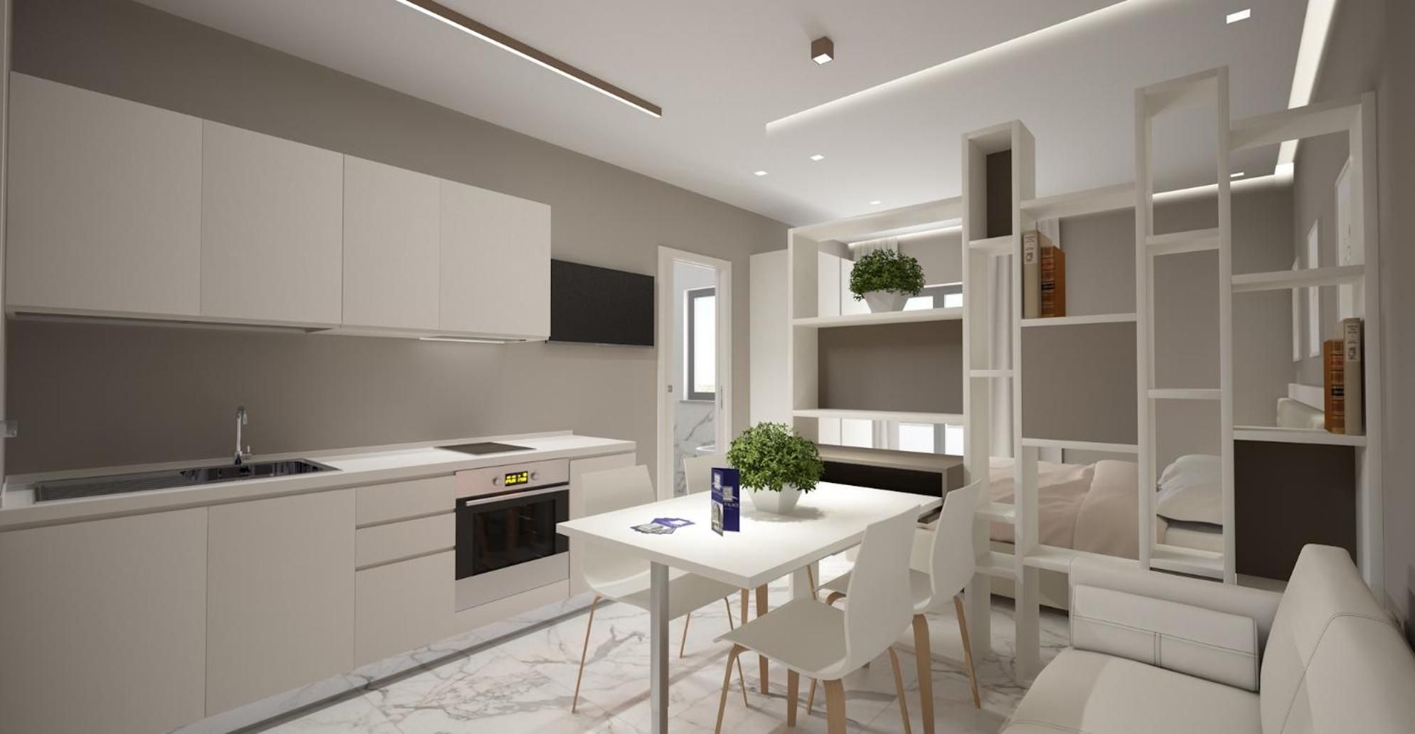 A modern kitchen with white cabinetry, a built-in oven, and a dining area with a white table and chairs.