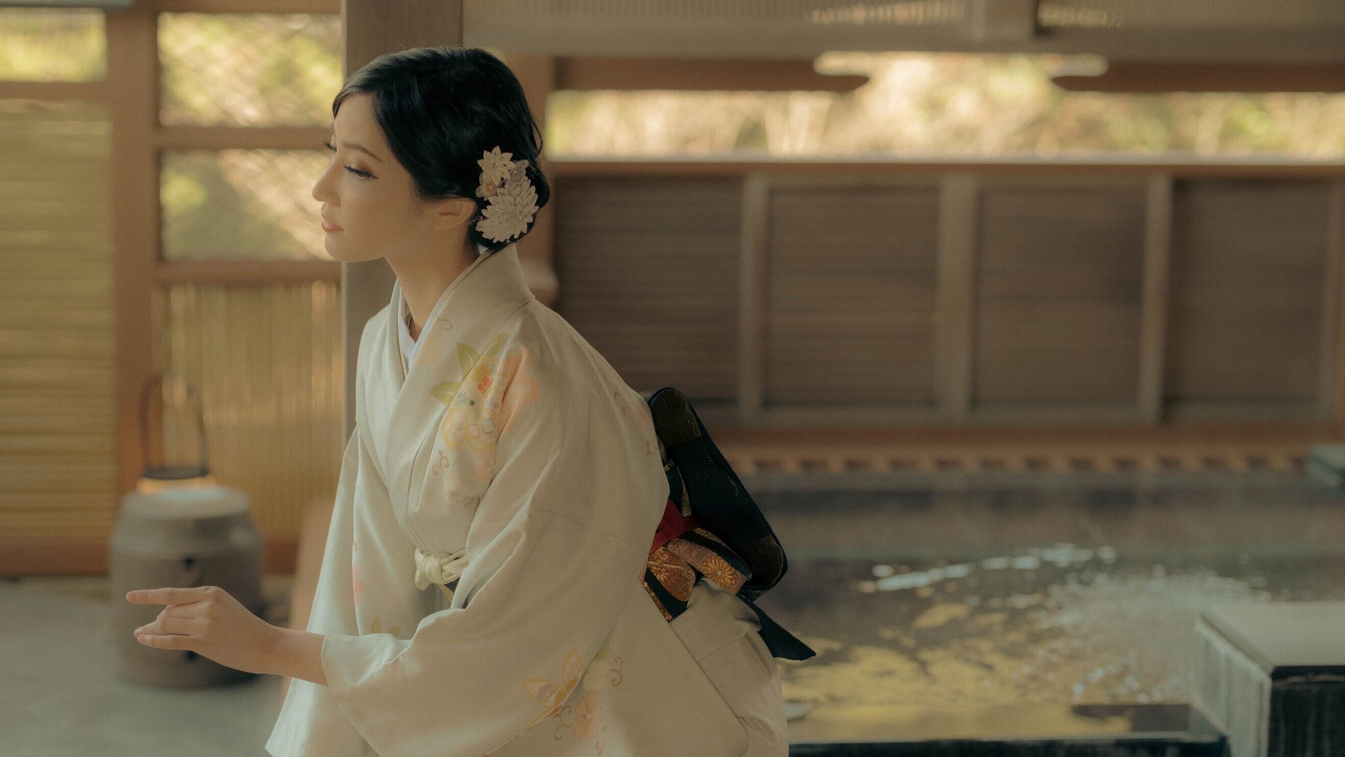 A traditional Japanese interior with tatami flooring and a wooden structure.