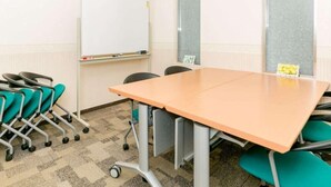 A conference room with a whiteboard, a table, and teal chairs. - Toyoko Inn Takasakieki Nishiguchi No 2 (Takasaki)