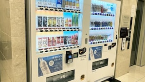 A vending machine with multiple beverage options and a water dispenser. - Toyoko INN Kokura-eki Shinkansen-guchi (Kitakyushu)