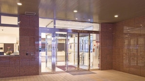A hotel entrance with a revolving door, a reception desk, and a tiled floor. - Toyoko INN Kokura-eki Shinkansen-guchi (Kitakyushu)