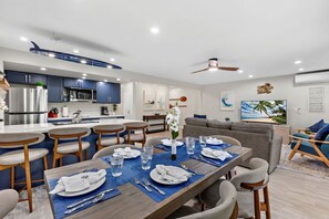 A modern kitchen with dark blue cabinets, a stainless steel refrigerator, and a microwave. - New Listing! Modern Garden Oasis in West Maui (Honokowai)