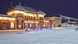 A historic building with multiple stories, featuring a brick facade and large windows. - Lillehammer Station Hotel & Hostel (Lillehammer)
