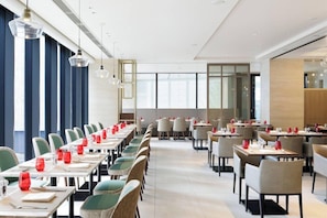 A modern dining area with long tables, chairs, and pendant lighting. - Courtyard BY Marriott Osaka Honmachi (Osaka)