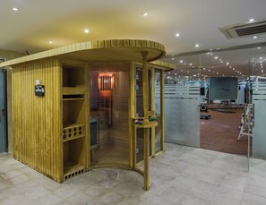 A wooden structure with a curved roof, a glass door, and a small table with items on it. - Rest Night Hotel Suites Al Hamra (Riyadh)