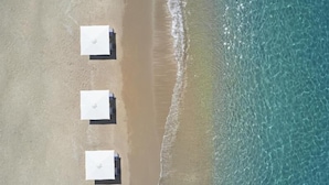 An aerial view of a beach with three umbrellas aligned in a row. - Marbella Elix (Igoumenitsa)