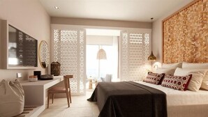 A modern bedroom with a bed, bedside table, chair, and a TV mounted on the wall. - Marbella Elix (Igoumenitsa)
