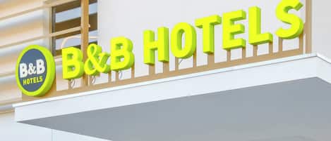 A B&B hotel sign with a circular logo and the name in bold letters.