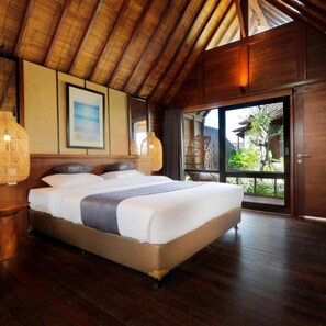 A bedroom with a large bed, wooden ceiling, and a view of greenery outside. - Bingin Lodge (Pecatu)