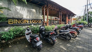 A BINGIN LODGE with a covered outdoor seating area and several parked scooters. - Bingin Lodge (Pecatu)