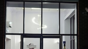 The exterior of Kegworth Hotel & Conference Centre with a modern glass facade, a reception area with seating, and a visible logo. - Kegworth Hotel & Conference Centre (Derby)