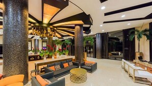 A spacious lobby with a central seating area, large pillars, and a modern chandelier. - Relax in Style at Luxury Beachfront Escape at Villa Del Palmer
5-Star Oceanfront (Cancún)