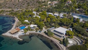An aerial view of a coastal property with a swimming pool, multiple buildings, and a beach area. - Lalibay Resort & Spa - Adults Only (Aegina)