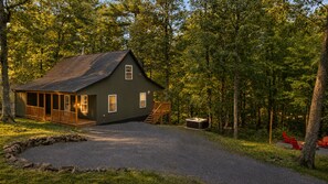A cabin with a porch, a fireplace, and a gravel driveway. - Peaceful Bryce Cabin + Hot Tub + Fire Pit + Pets - 3 BR + Loft (Mount Jackson)