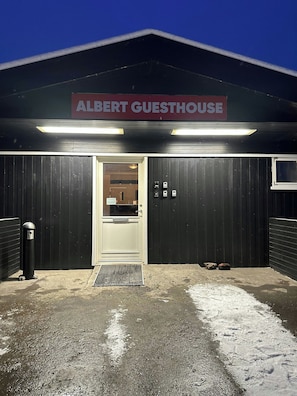 A building with a sign reading 'ALBERT GUESTHOUSE' at the entrance.