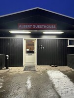 A building with a sign reading 'ALBERT GUESTHOUSE' at the entrance.