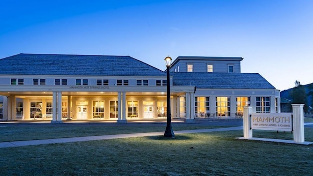 A two-story hotel with a covered front entrance and a sign reading "Mammoth Hot Springs Hotel & Casino". - Mammoth Hot Springs (Yellowstone National Park)